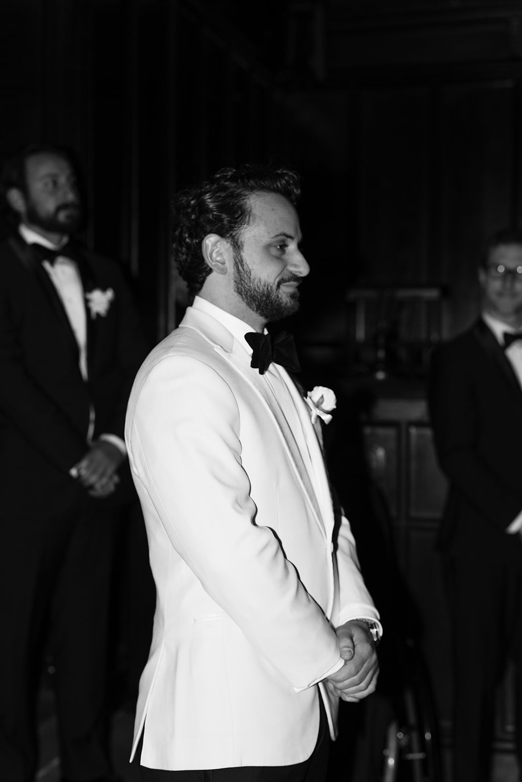 Groom anxiously awaits as his bride enters the elegant wedding ceremony