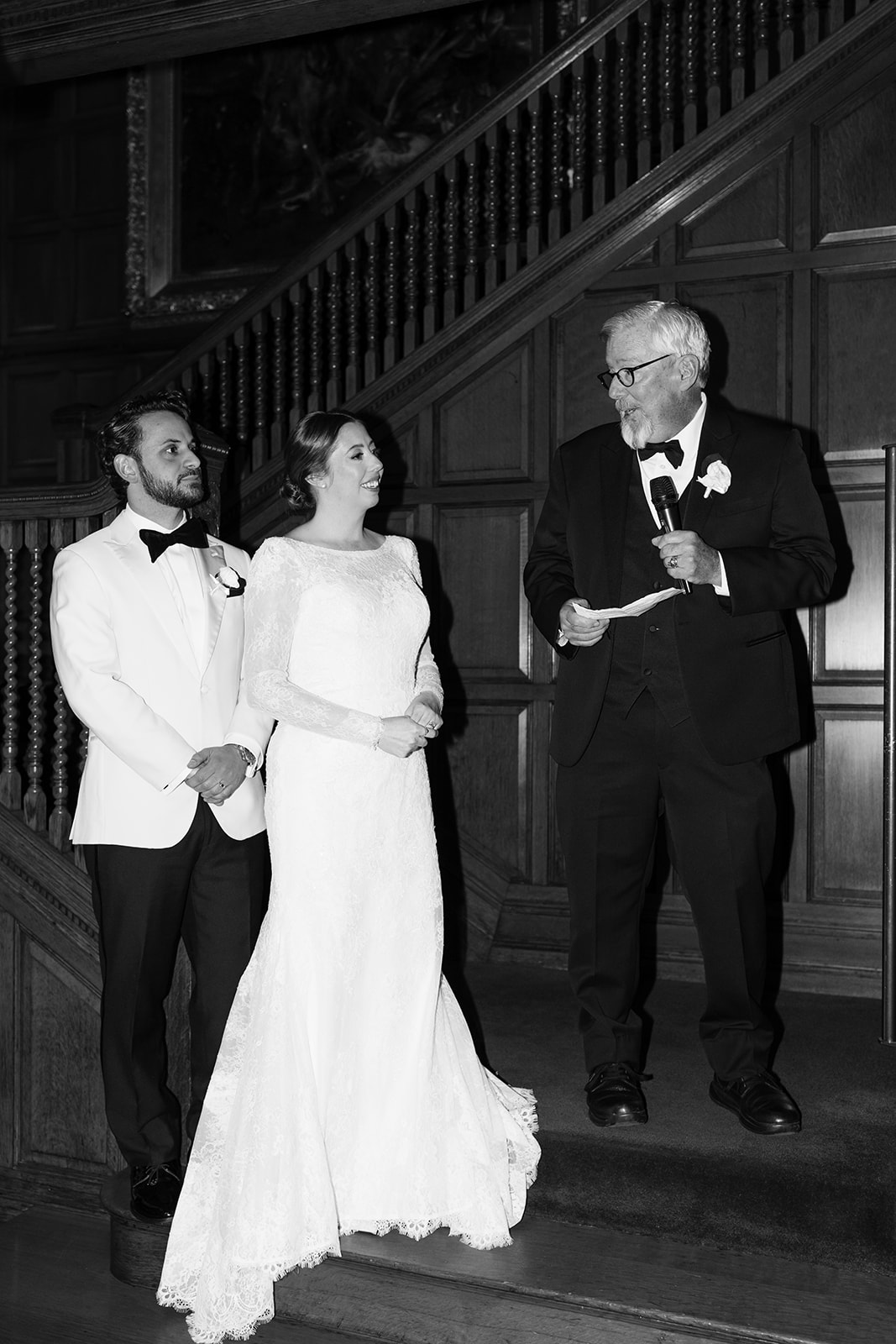 Bride and groom pose together with their father in law
