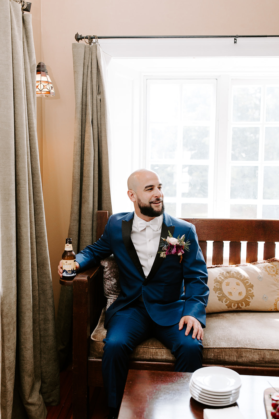 handsome groom enjoys a beer to knock the edge off before his dreamy wedding day