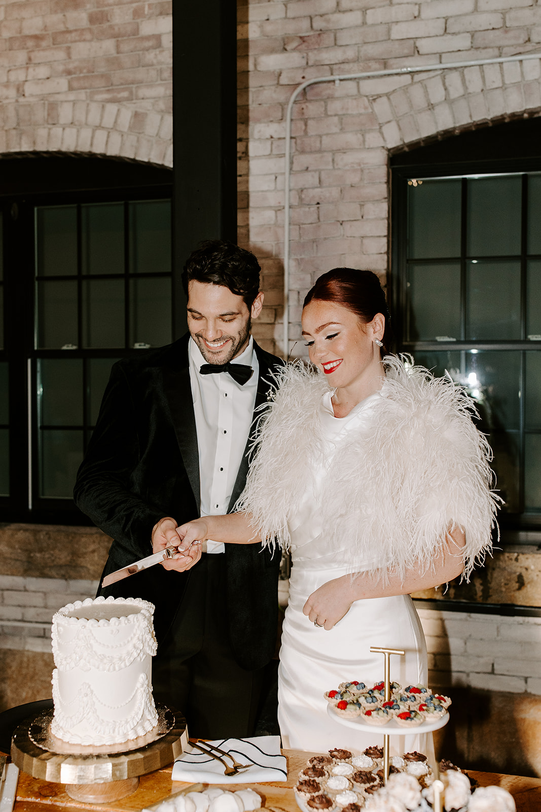 beautiful bride and groom cut their 2 tier wedding cake