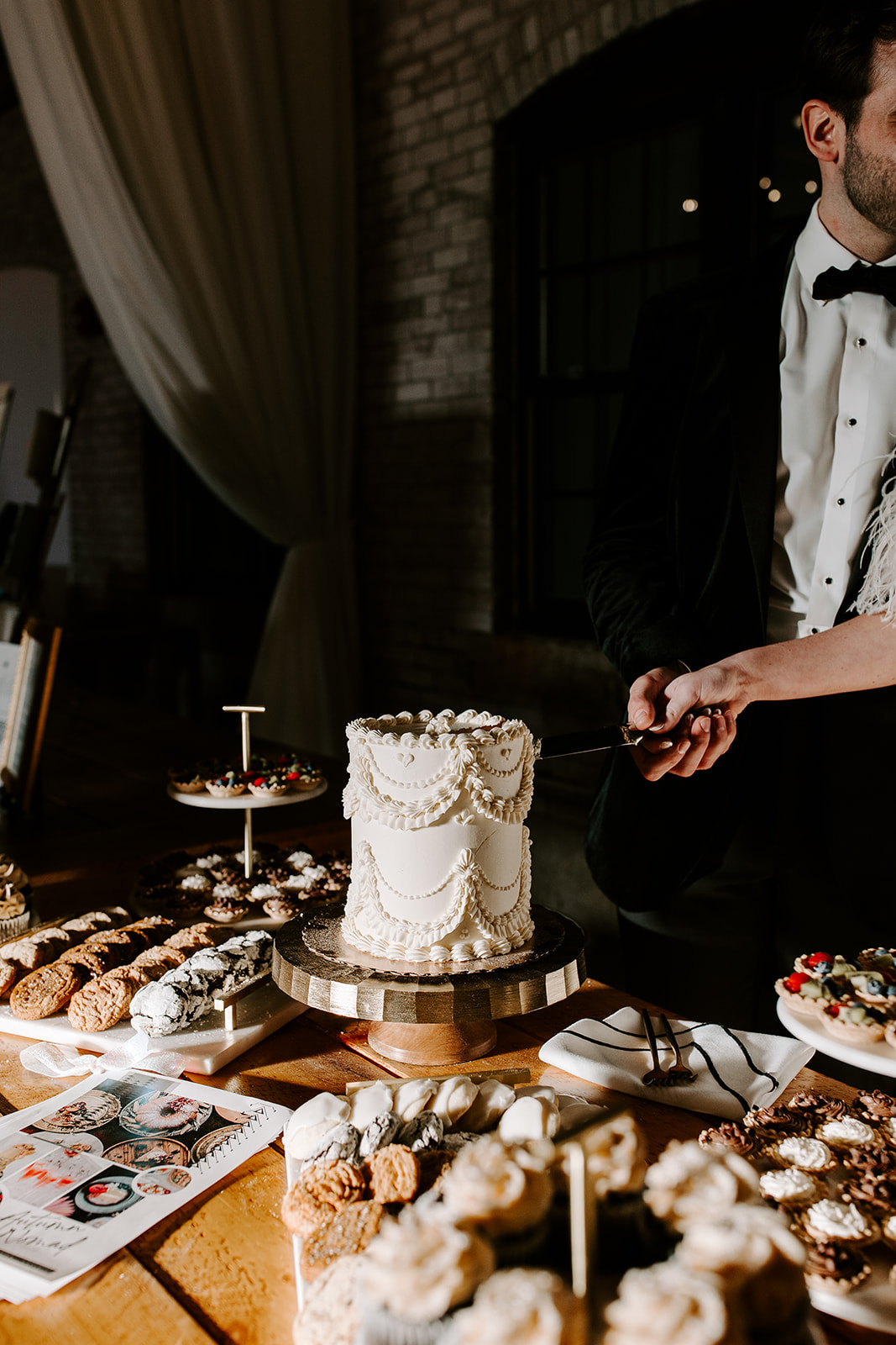bride and groom cut their cake to share with the guests