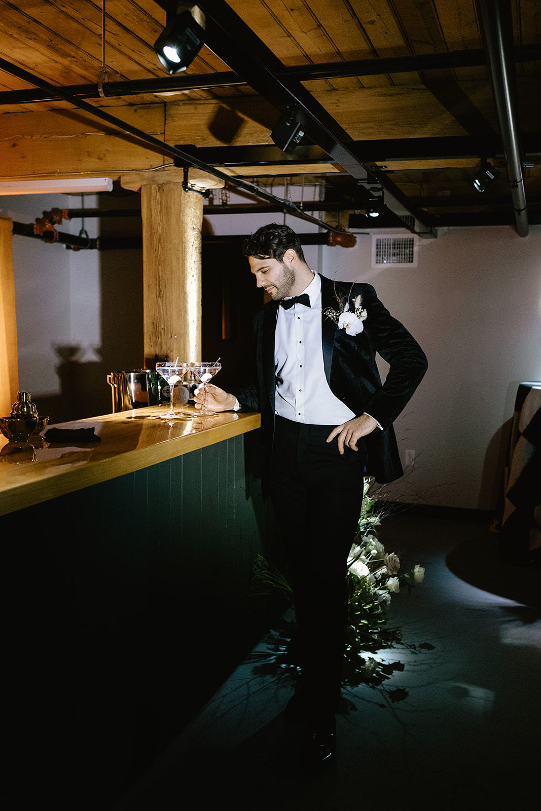 groom drinks at the bar after his stunning wedding day