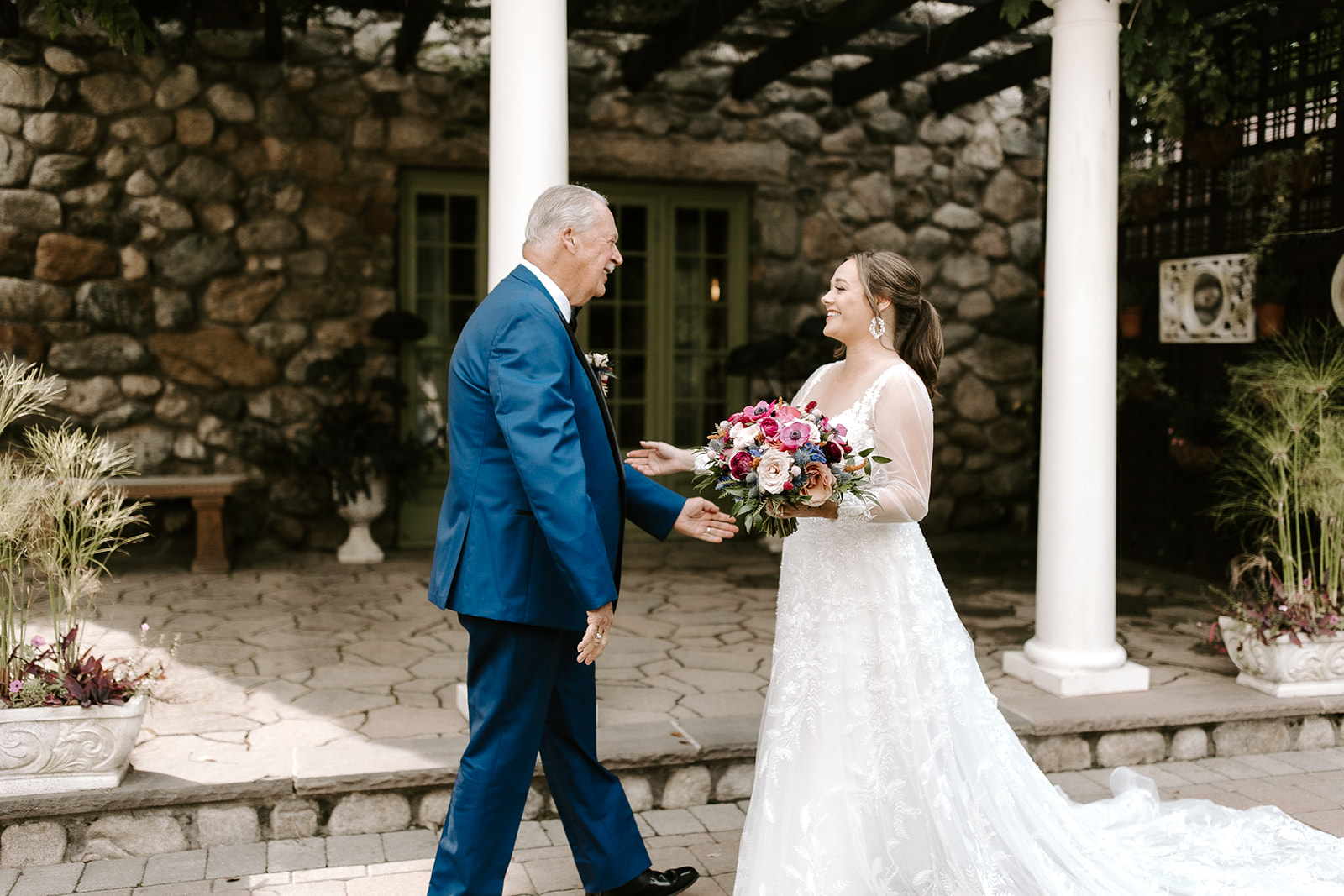 bride shares a loving moment with her dad during their first look photoshoot