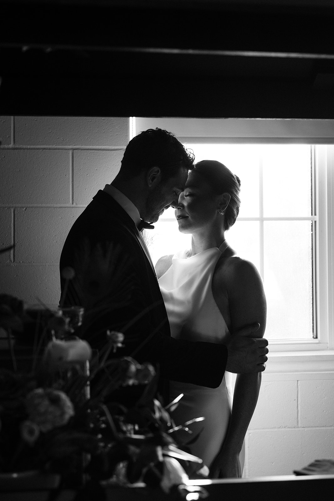 bride and groom pose intimately together