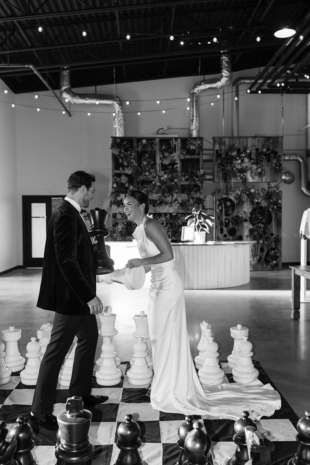 stunning bride and groom play the giant chess board at The Factory wedding venue