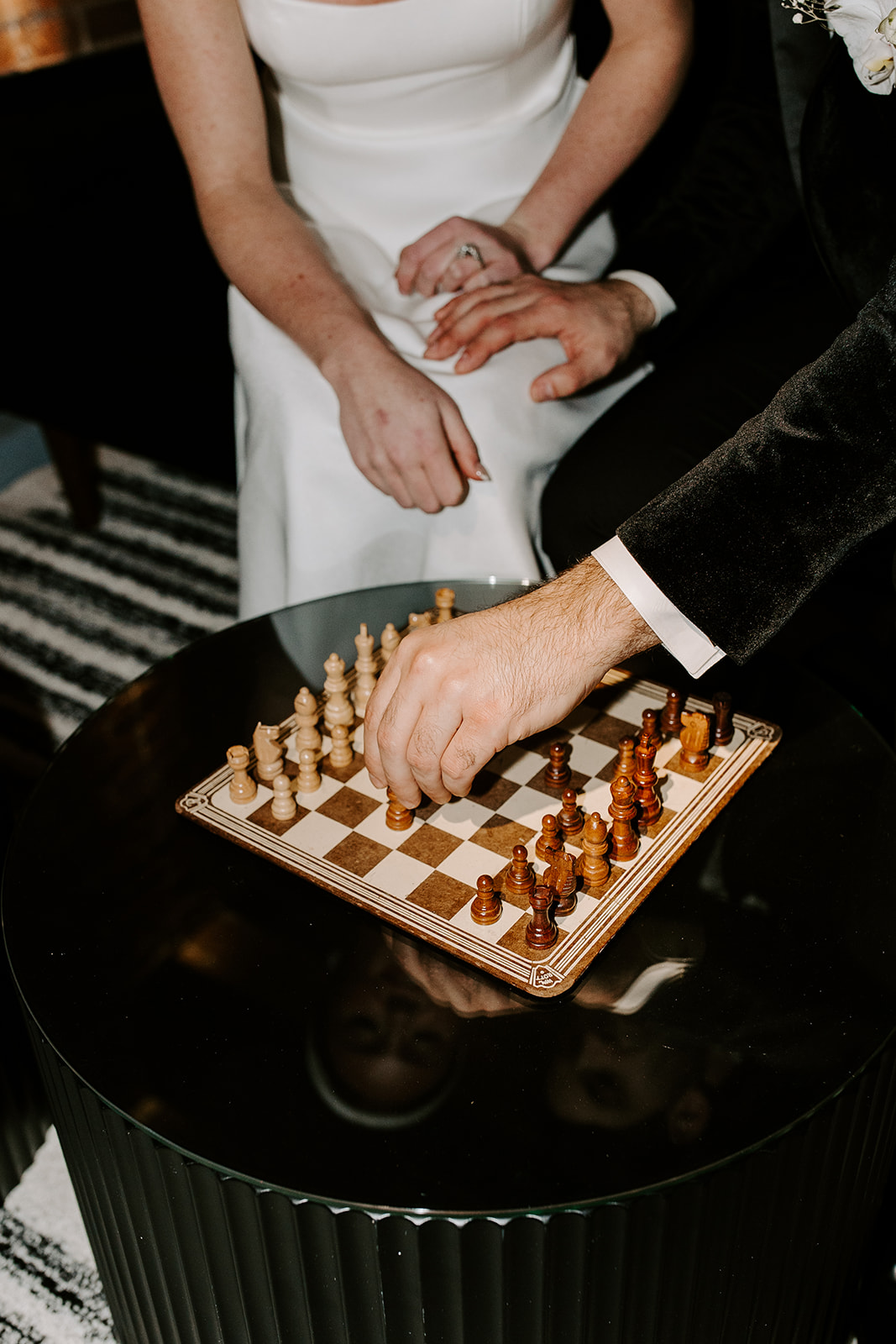 bride and groom play chess after their dreamy wedding at The Factory