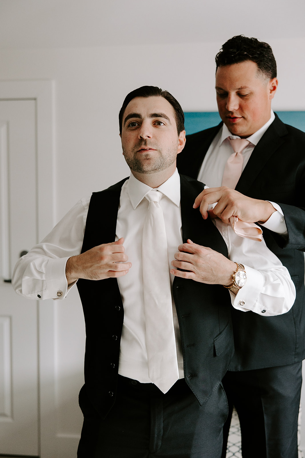 handsome grooms add final touches as he finishes prep for his stunning wedding day