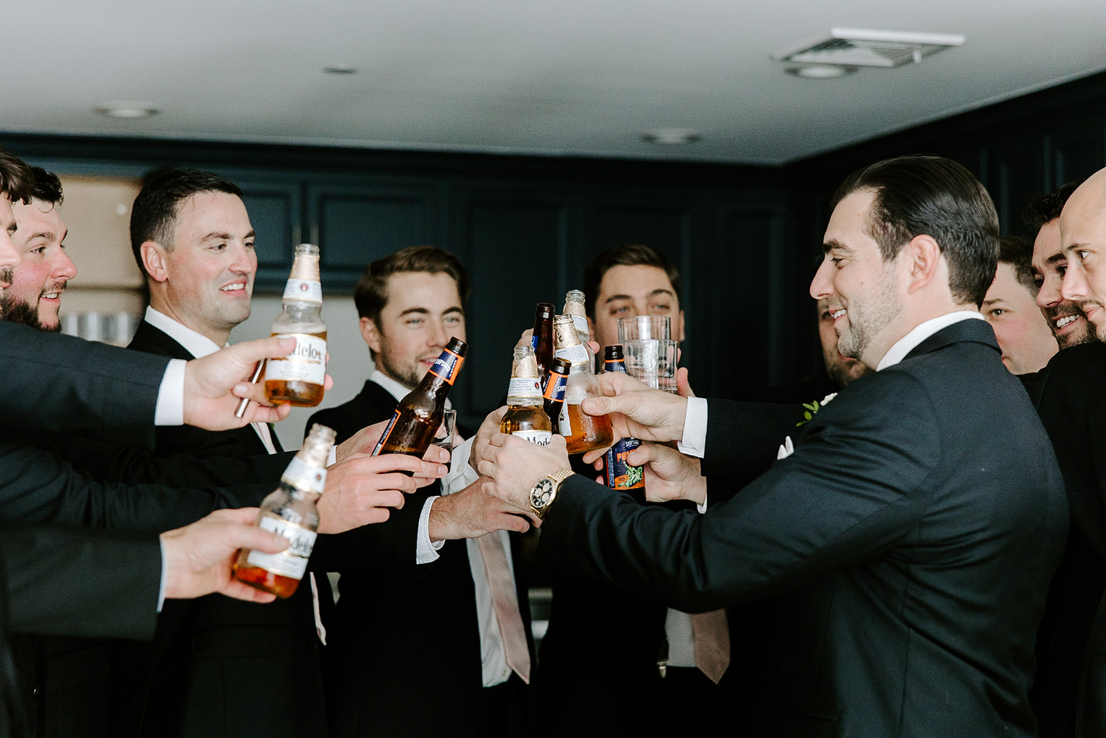 Groomsmen share a toast with the groom shortly before the stunning wedding day
