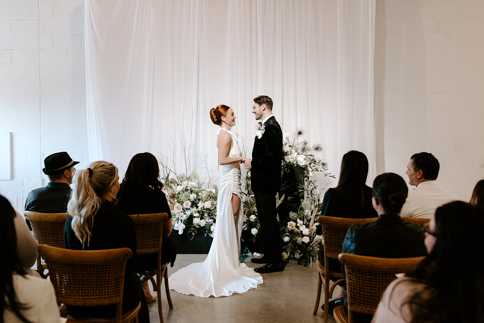 beautiful bride and groom have their intimate wedding ceremony in as their guests look on 