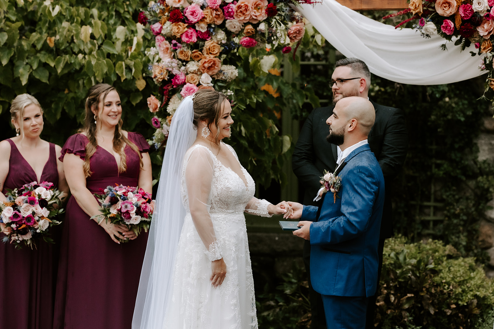 bride and groom hold hands and exchange vows during their stunning willowdale wedding ceremony
