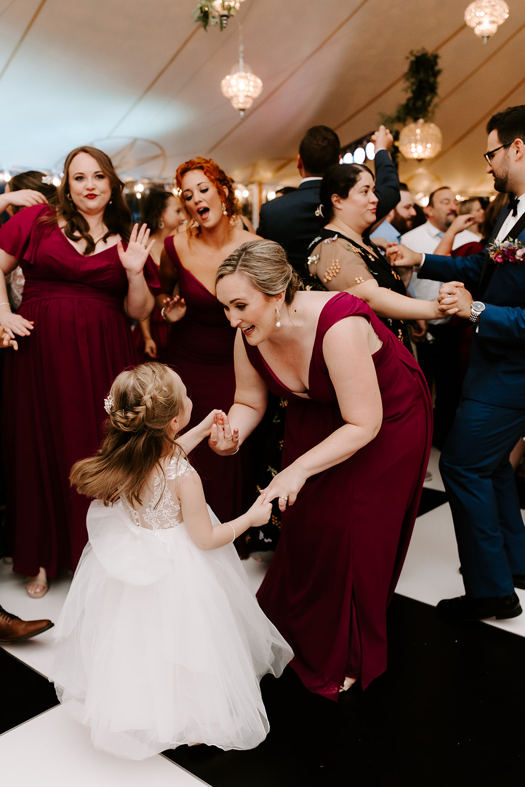 bridemaids celebrate and dance during the timeless indoor wedding reception