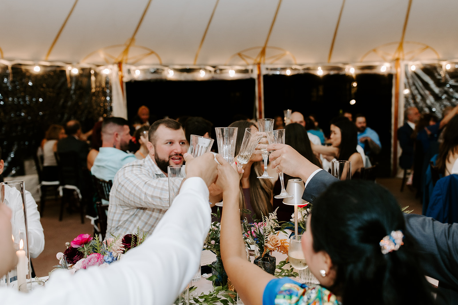 Guests celebrate and toast during the stunning willowdale estate wedding reception