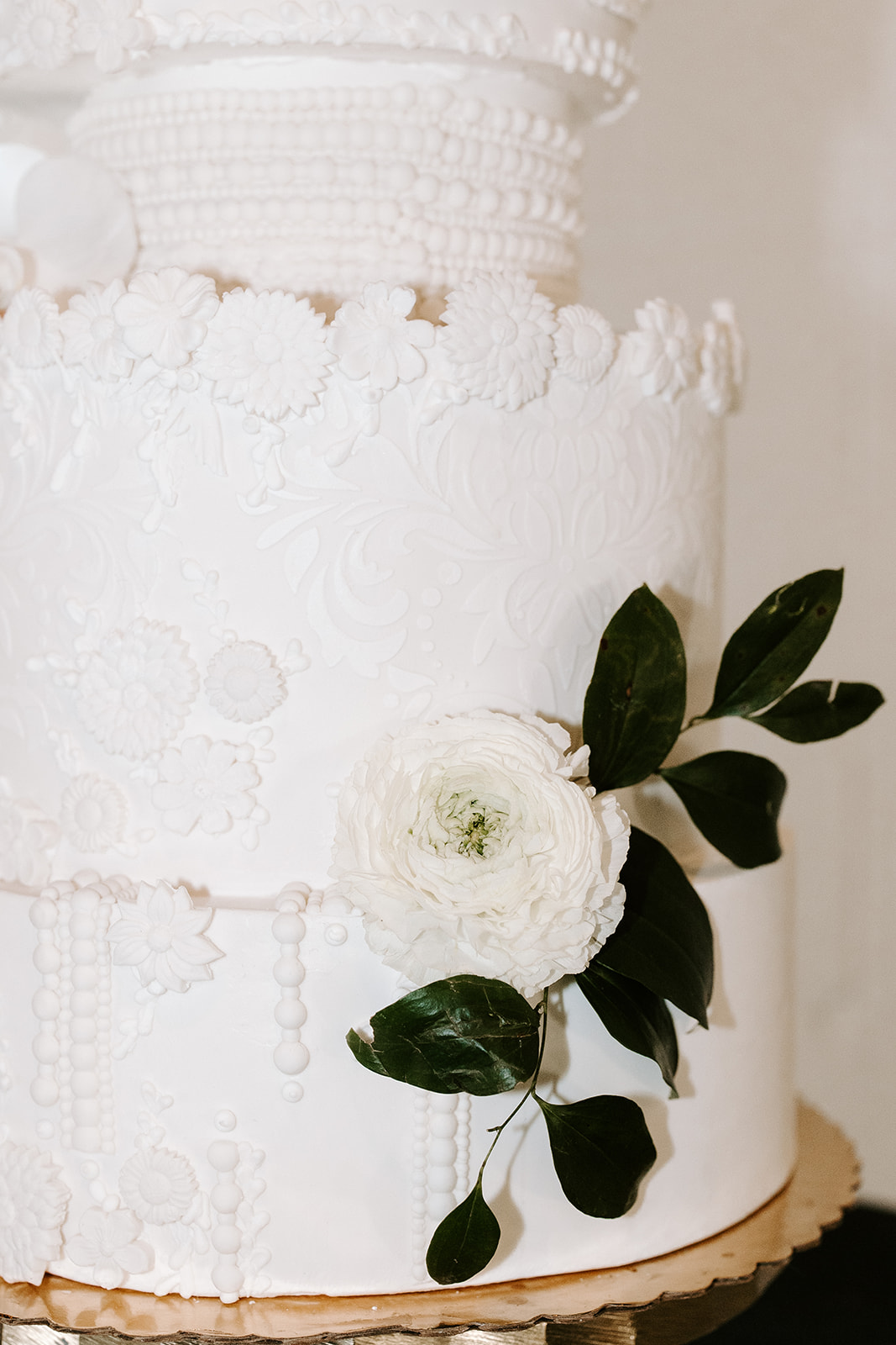 stunning detail shot of the beautiful white 3 tier wedding cake