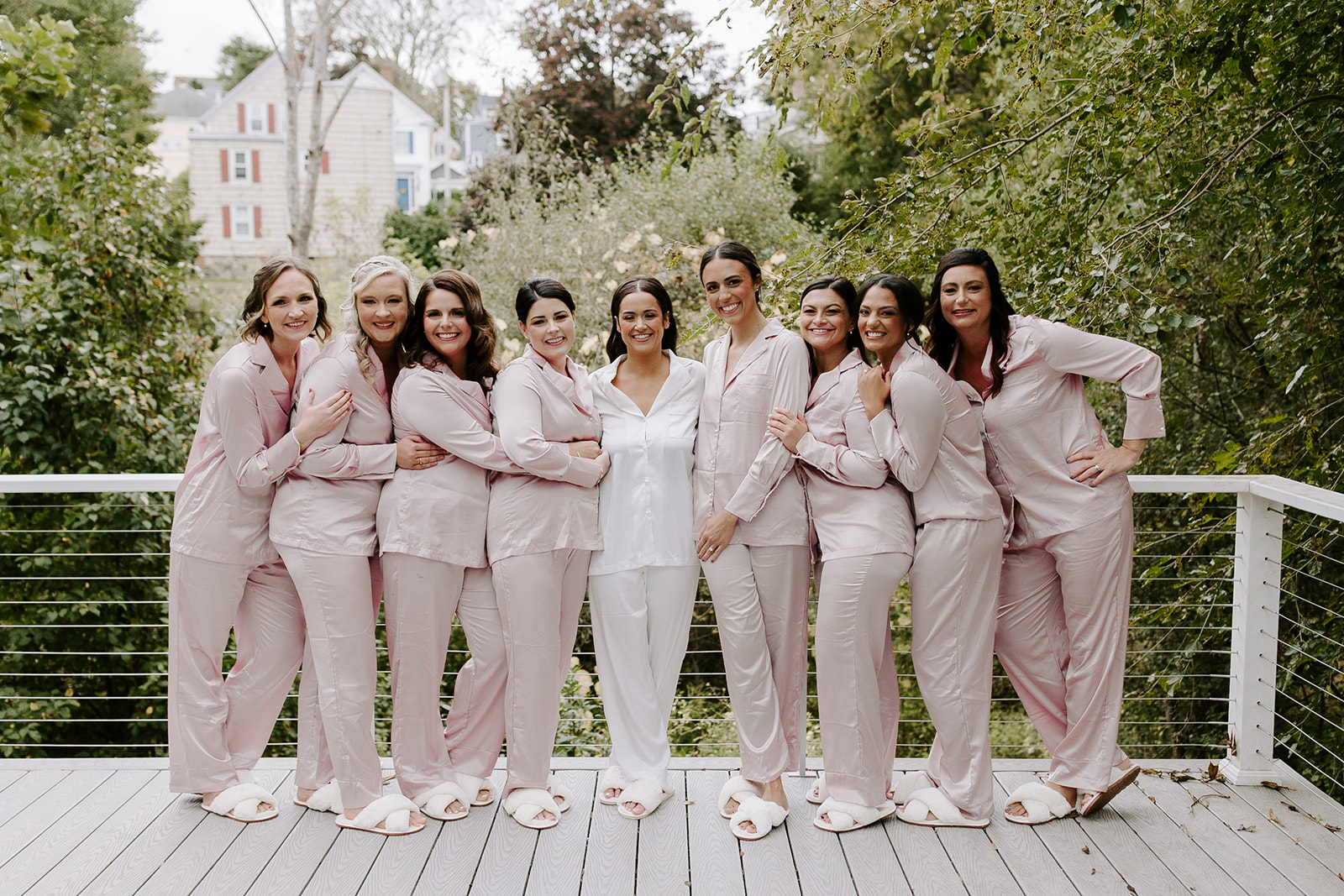 Bridesmaids pose with the stunning bride before her dreamy New England wedding day