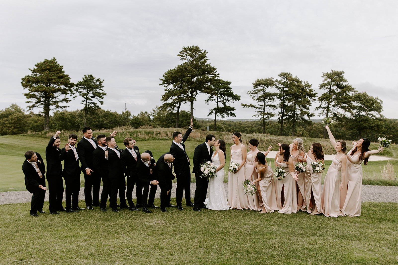 The wedding party poses together after the dreamy New England wedding