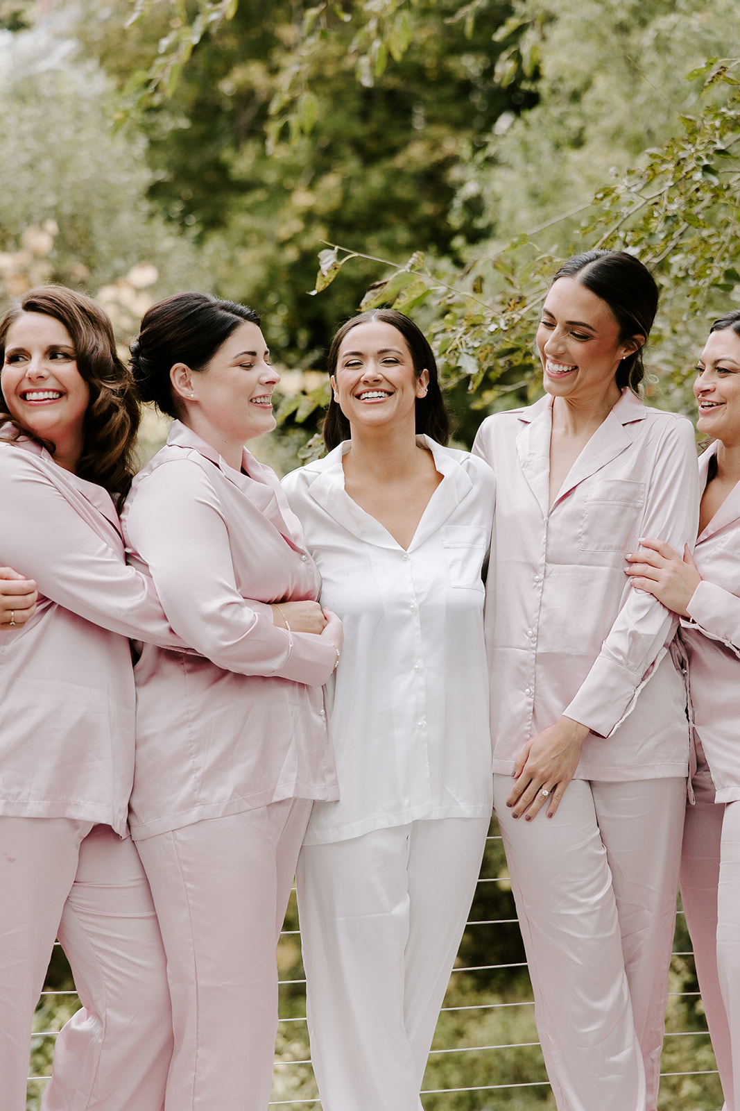 Bridesmaids pose with the stunning bride before her dreamy New England wedding day