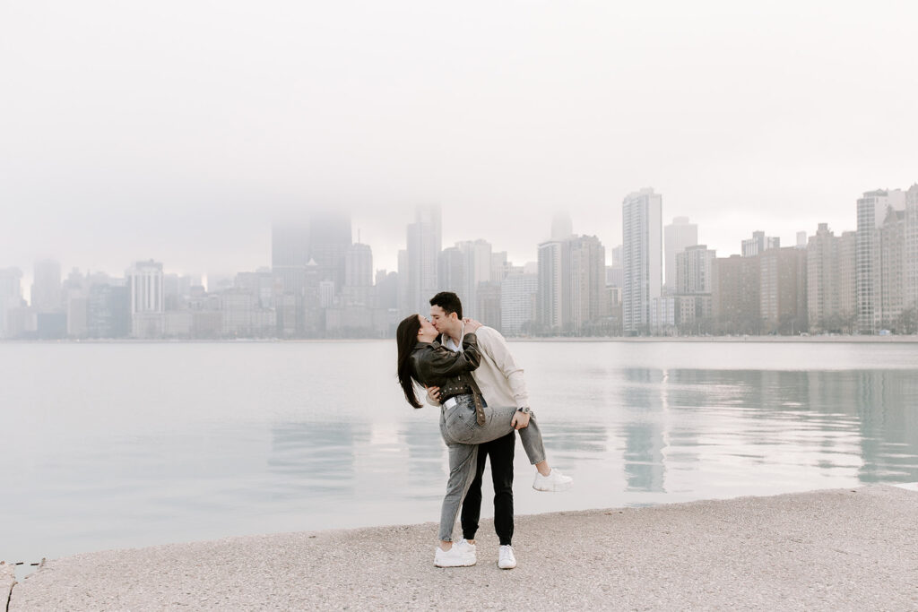 stunning couple shares a kiss with the Chicago skyline in the background