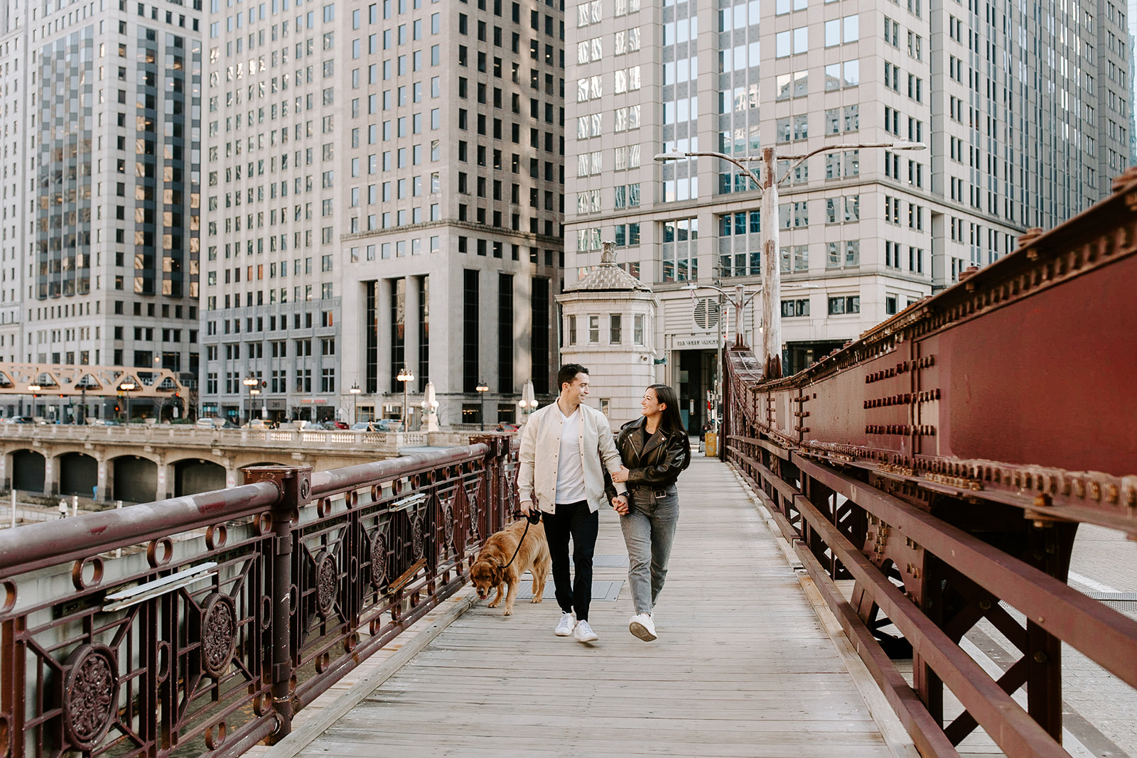 stunning couple walk together with the Chicago in the background