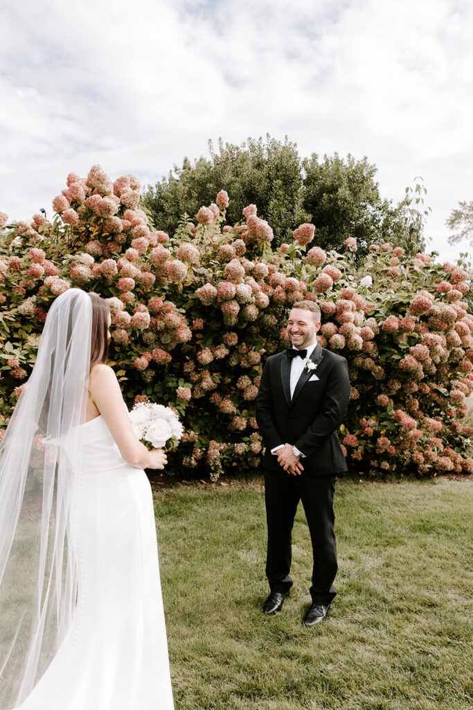 groom seeing bride for the first time during first look