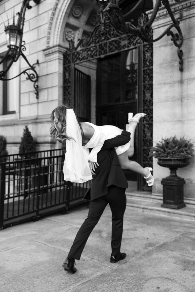 groom carrying bride