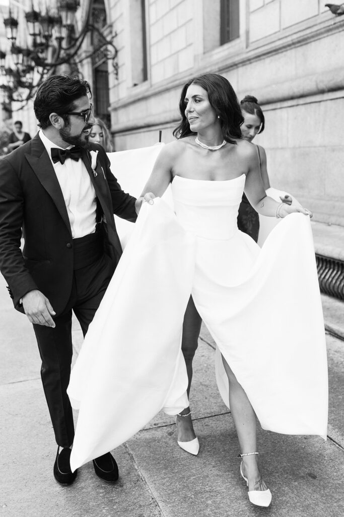 bride and groom vintage glam walking down city street
