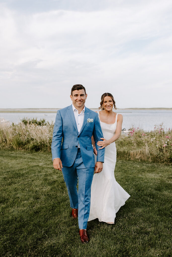 Bride and groom silhouetted against a glowing Cape Cod sunset during their backyard wedding.