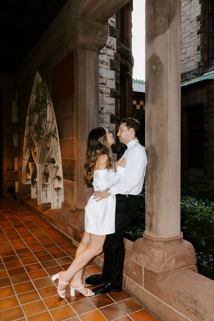 Editorial-style portrait with couple framed by church architecture