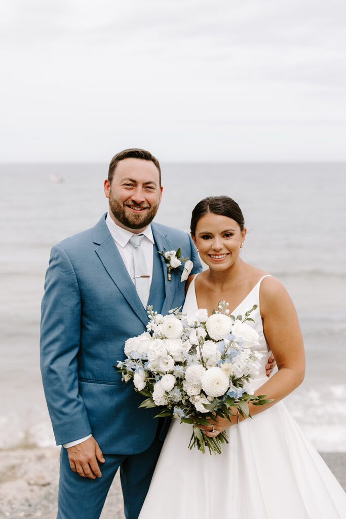 Romantic portrait of bride and groom by the cliffs and ocean