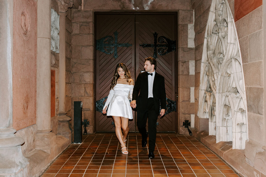 Elegant pose of couple in front of dramatic architectural backdrop