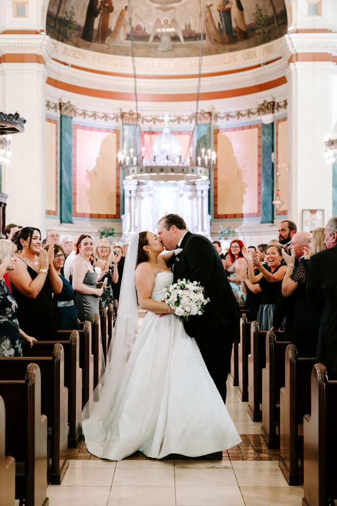 Bride and groom’s first kiss as husband and wife at altar