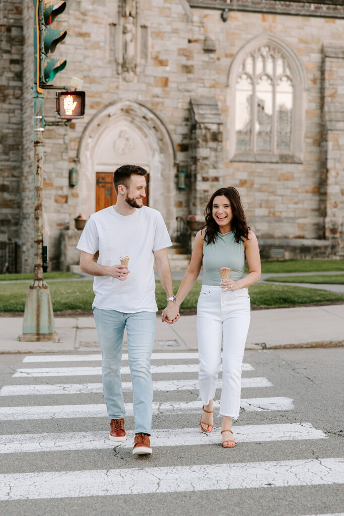 Couple walking hand-in-hand across Boston College campus
