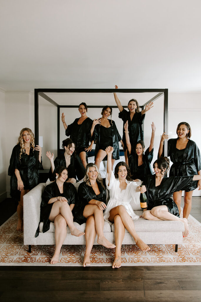 Bridesmaids in matching silk robes toasting with champagne before the Armenian wedding ceremony