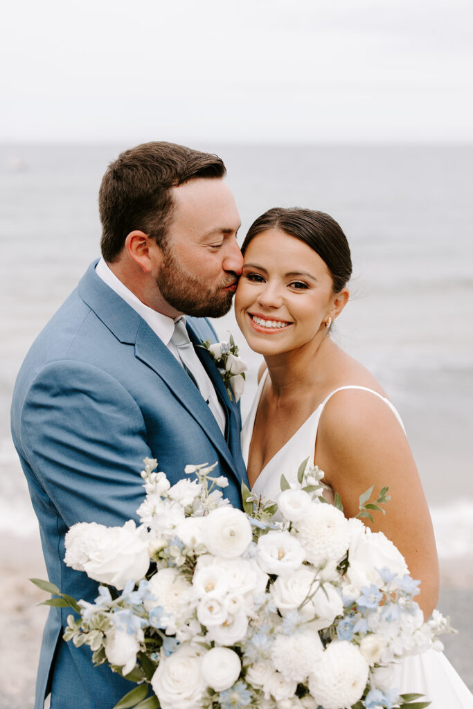 groom kisses bride tenderly on the cheek