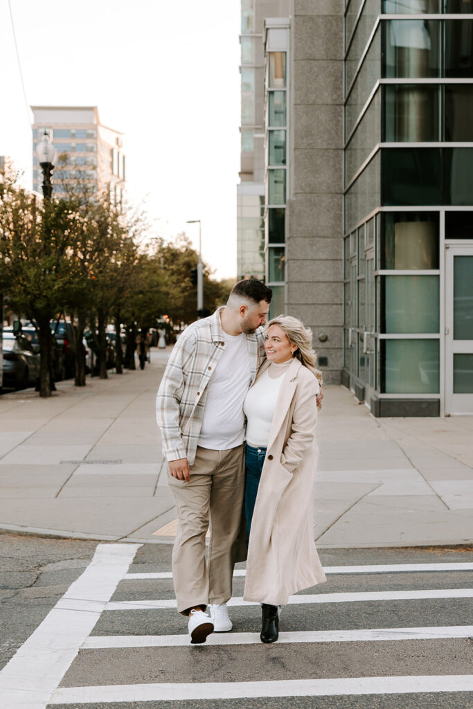 cute couple smiling and crossing street