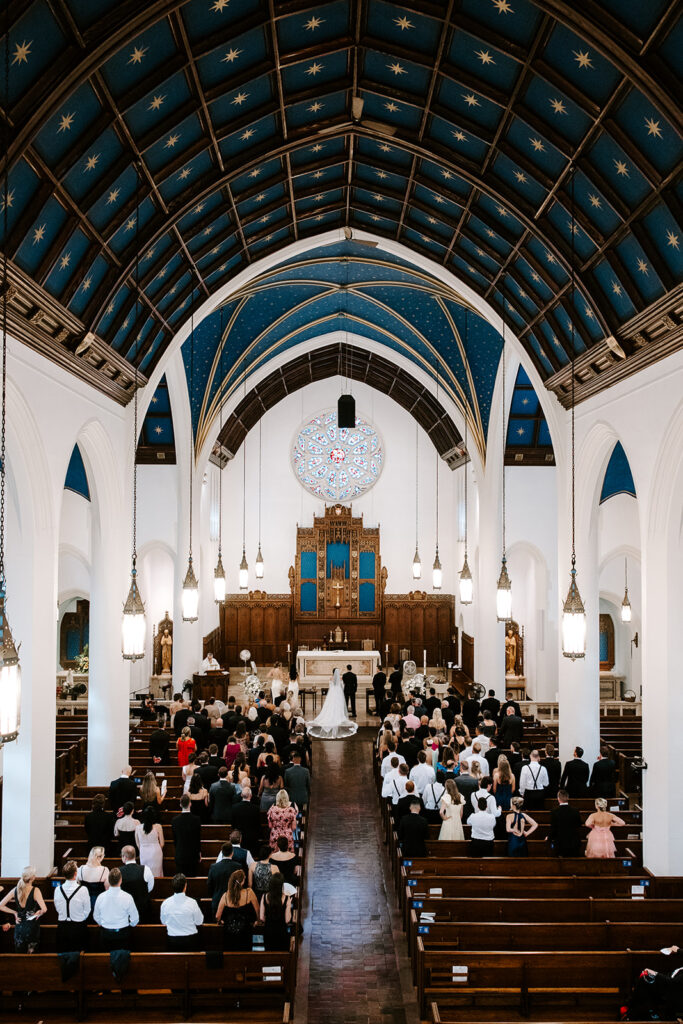 Couple exchanging vows at church altar