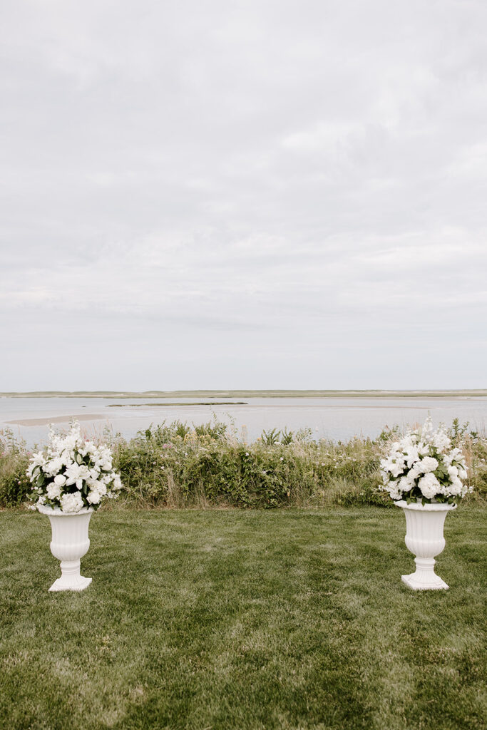Floral ceremony arch designed by Fancy Flowers by Meredith, framing the couple’s vows