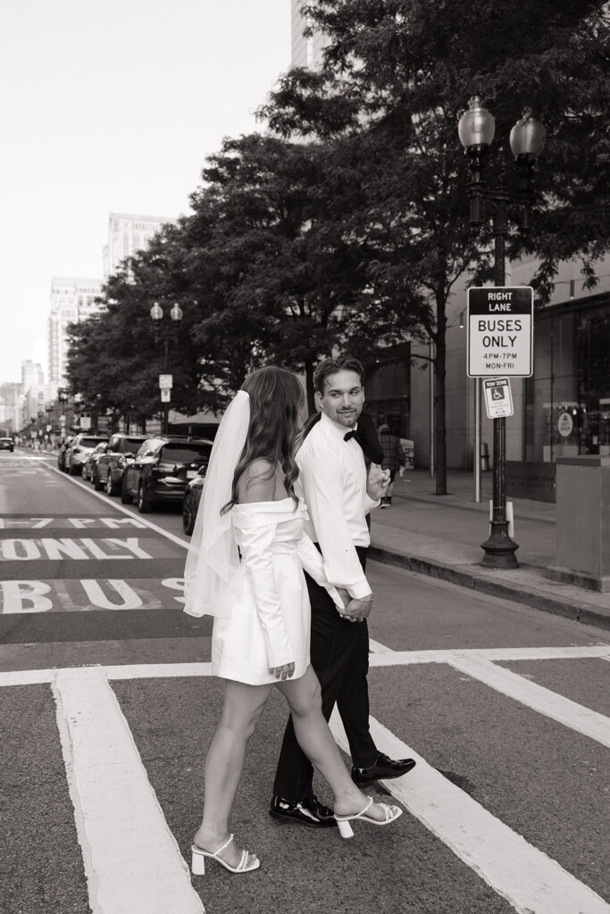 Engagement photo of couple crossing street near Copley Square
