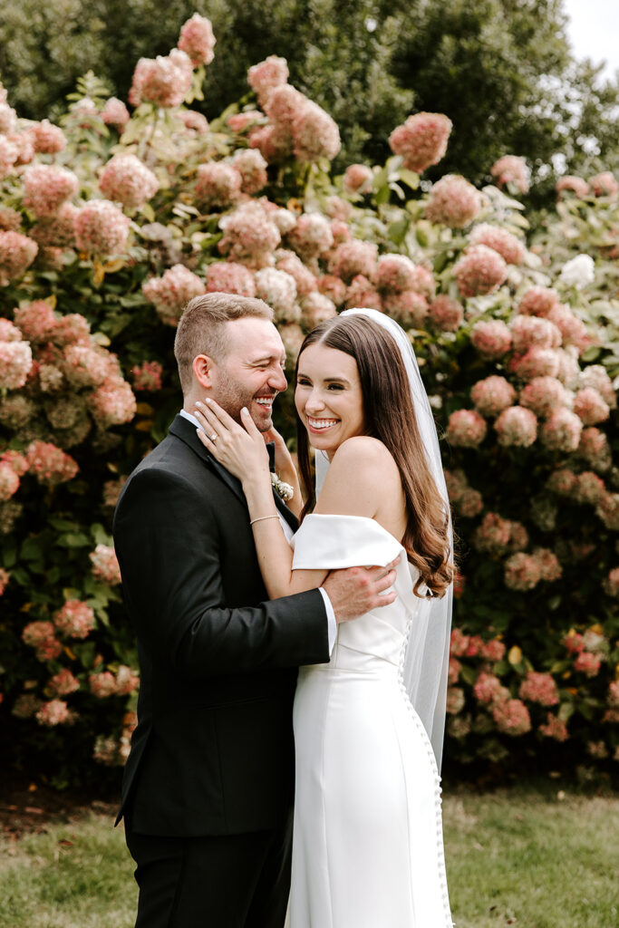 Bride and groom sharing a candid laugh in natural light