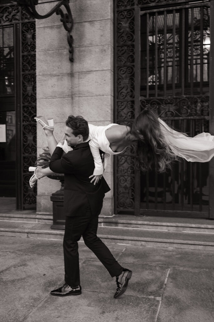 groom carrying bride around