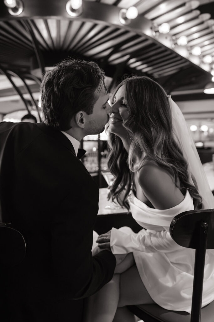 Couple laughing over drinks at chic restaurant bar in Boston