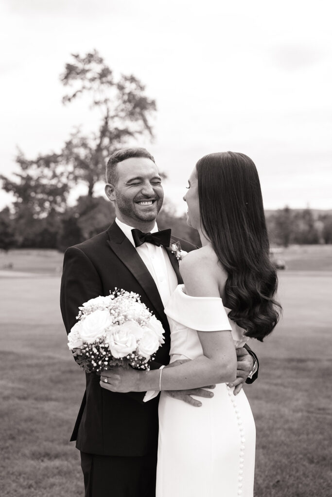 Close-up of couple smiling at each other with sun flare in background