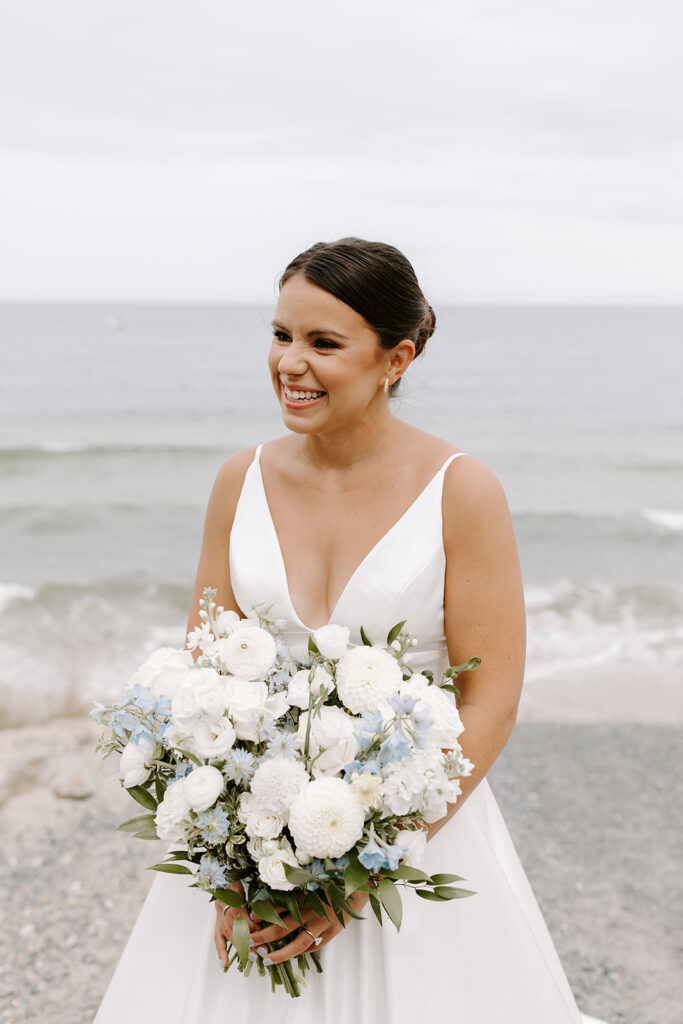 bride holding white and blue bouquet