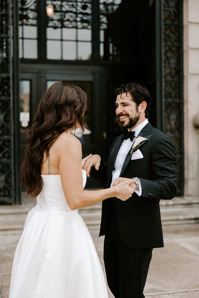 bride and groom first look outside boston public library