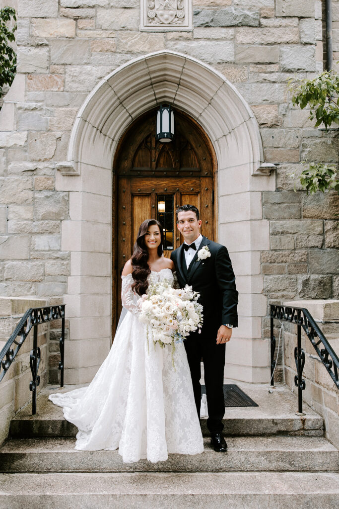 newlyweds posed in front of church
