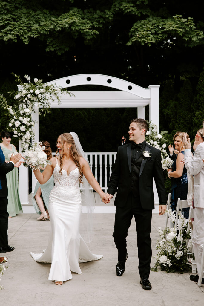 newlyweds joyfully walking down aisle