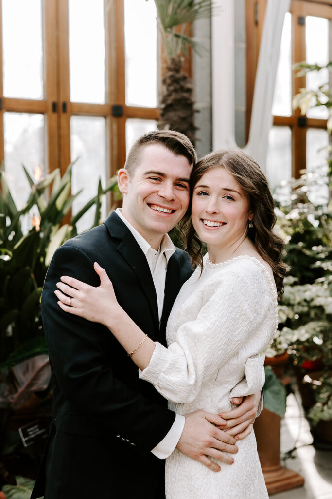 Natural light engagement photo with botanical plants and glass ceiling