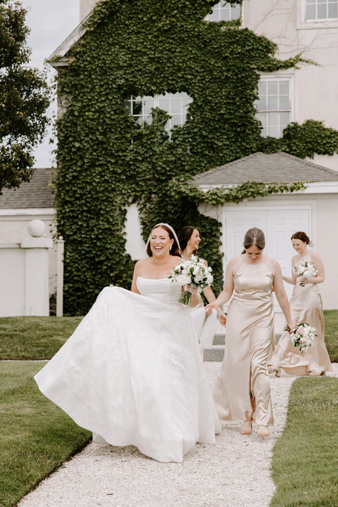 bridesmaids walking across belle mer lawn