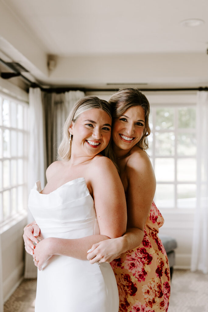 bride and sister getting ready