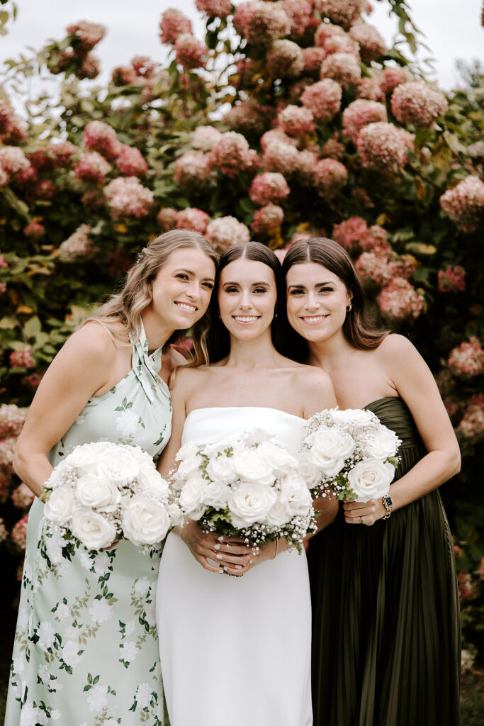 Bridesmaids in soft dresses holding matching bouquets