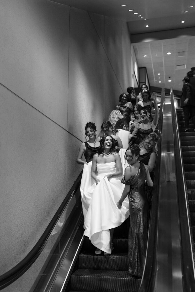 bride going down escalator to see groom for the first time